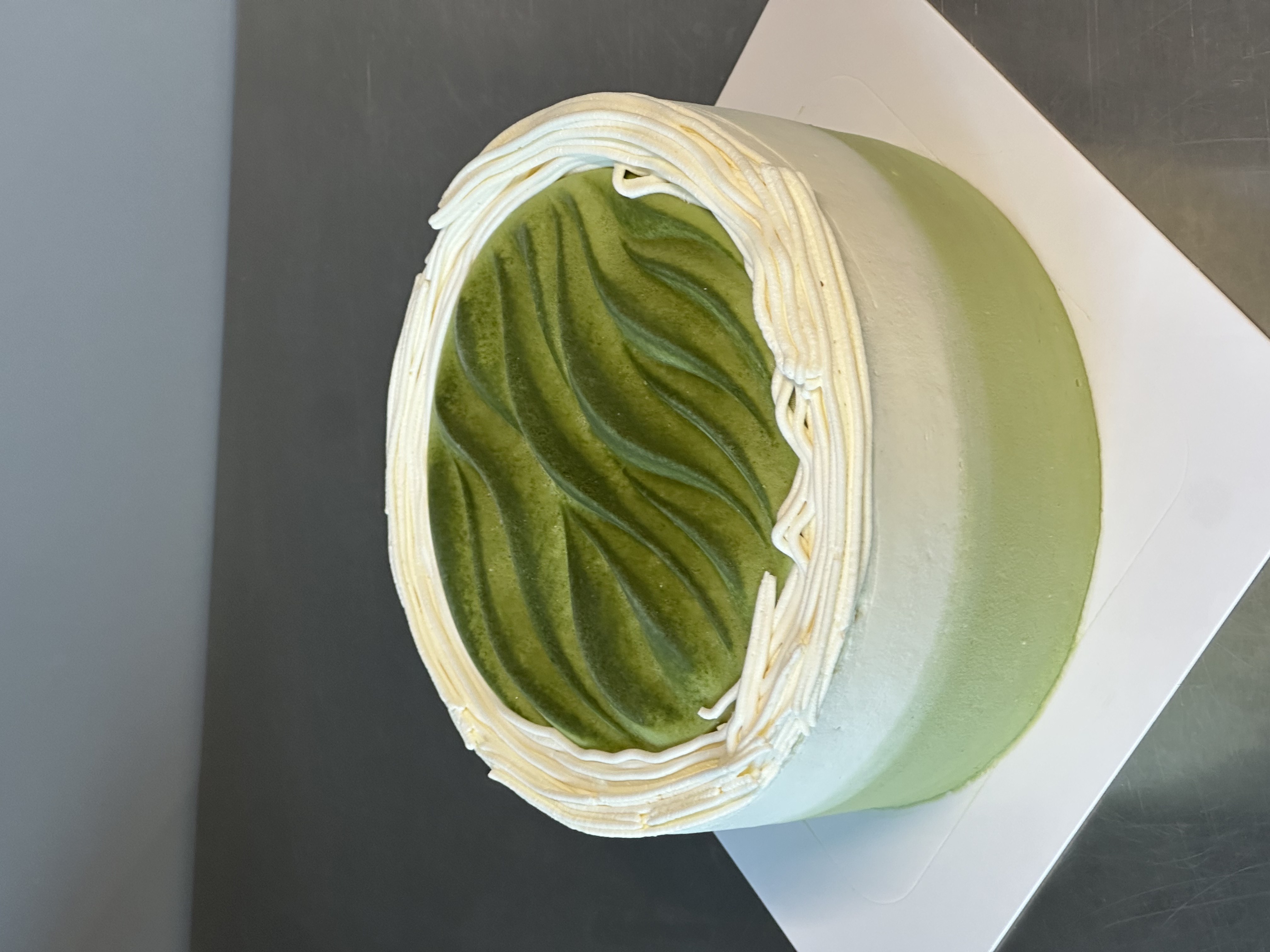 Whole Matcha Yuzu cake with matcha top and cream border