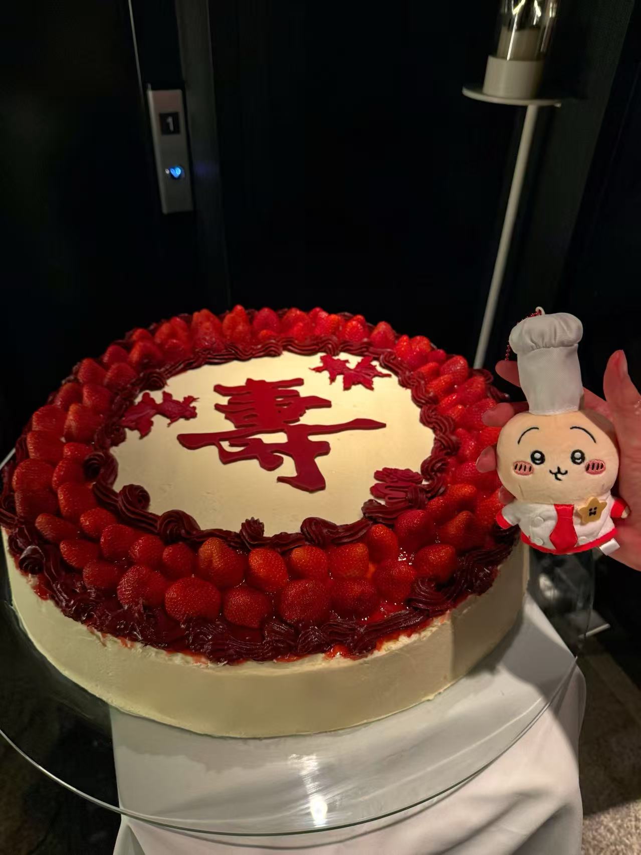 Large-format celebration cake shown as a completed table centrepiece